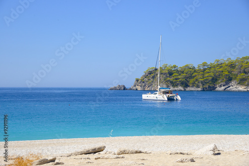 The white catamaran anchored near beach


