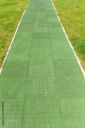 old green running tracks with grass