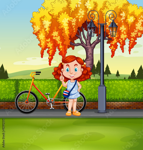 Little girl and bicycle in the park