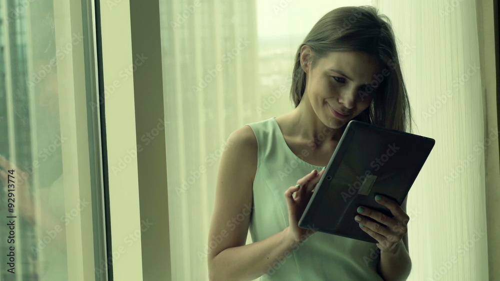 Young, pretty businesswoman using tablet computer by window
Young, pretty businesswoman using tablet computer by window