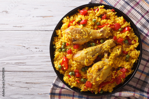 Spanish paella with chicken and vegetables. horizontal top view
