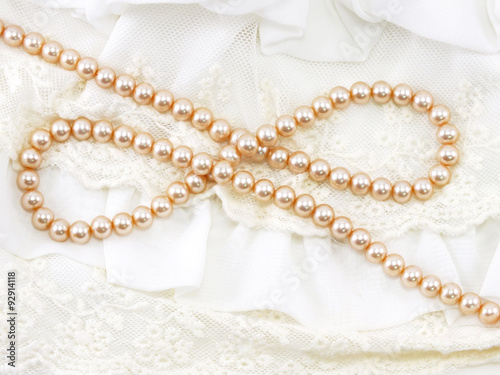 beautiful creamy pearl necklace on a lace background