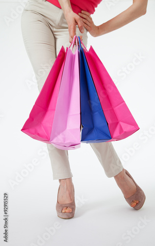 Young woman in pants with shopping bags