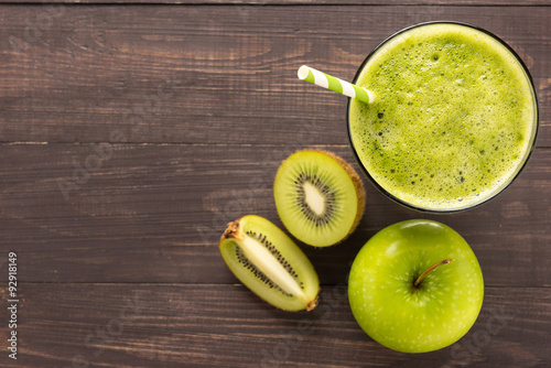 Healthy green smoothie with kiwi, apple on rustic wood backgroun