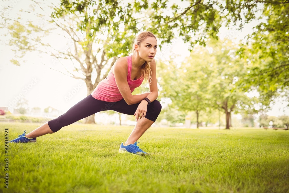 Beautiful woman exercising with stretching leg Beautiful woman exercising with stretching leg