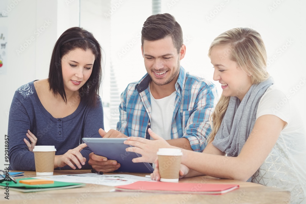 Smiling colleagues working using digital tablet Smiling colleagues working using digital tablet