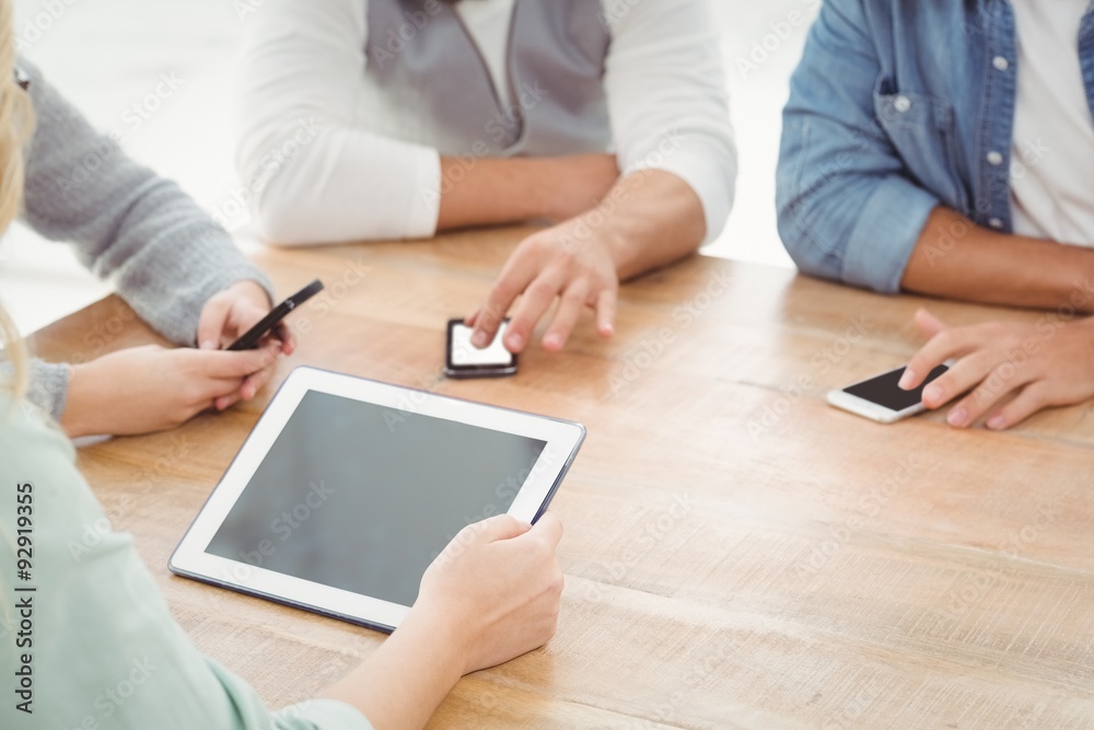 Mid section of people using smartphones and digital tablet Mid section of people using smartphones and digital tablet