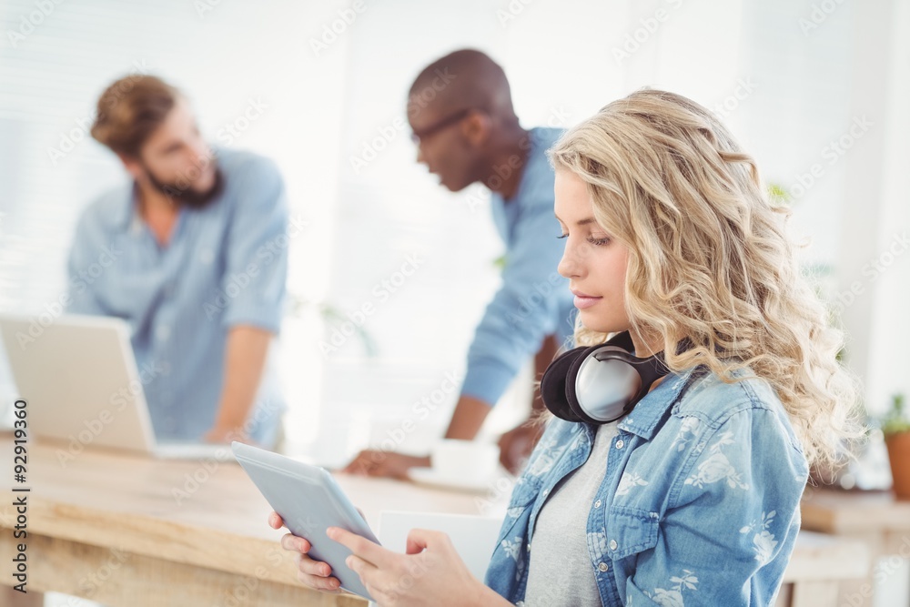 Side view of woman with headphones while using digital tablet Side view of woman with headphones while using digital tablet