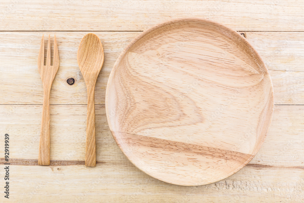Empty wooden plate and spoons, forks. Empty wooden plate and spoons, forks.