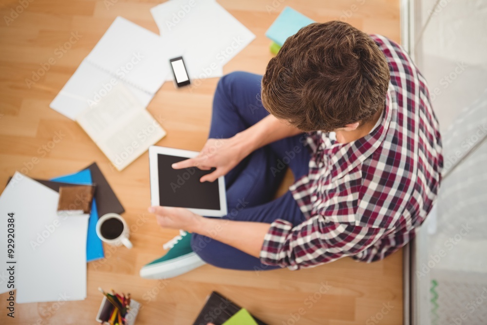Creative businessman working on digital tablet in office Creative businessman working on digital tablet in office