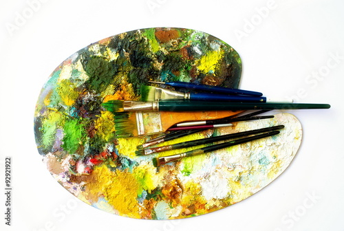 Paint brushes to the painting palette with colors 