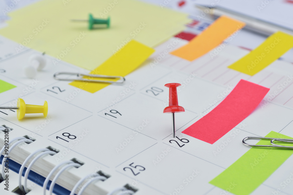 Pin with colorful sticky notes and pin on business diary page Pin with colorful sticky notes and pin on business diary page