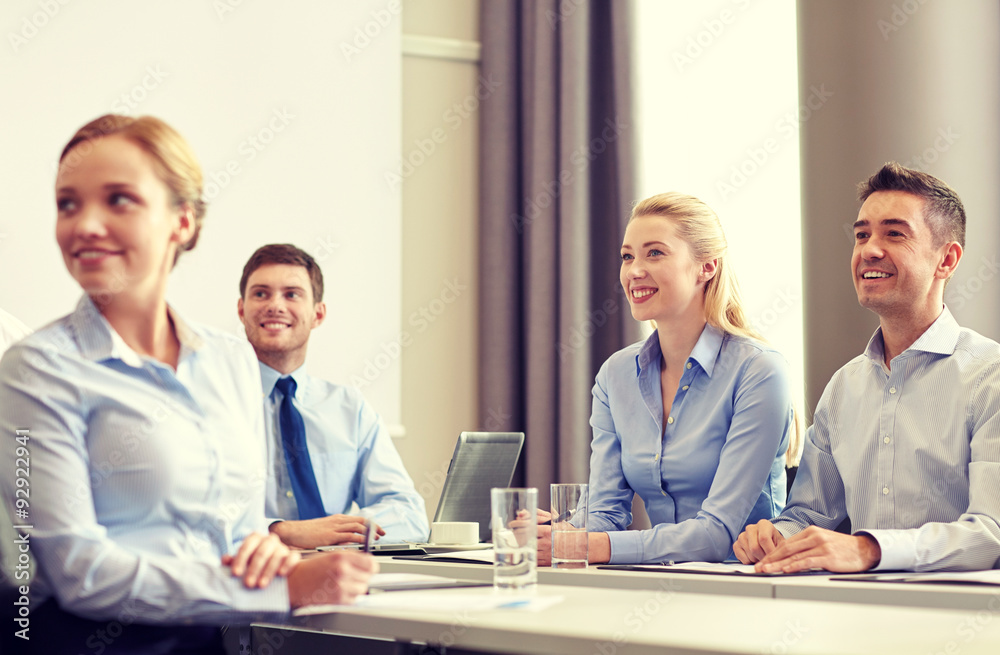group of smiling businesspeople meeting in office group of smiling businesspeople meeting in office