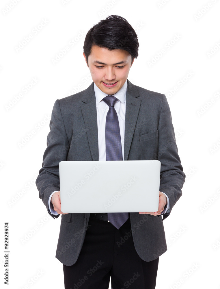 Asian Young Businessman read on the laptop computer Asian Young Businessman read on the laptop computer