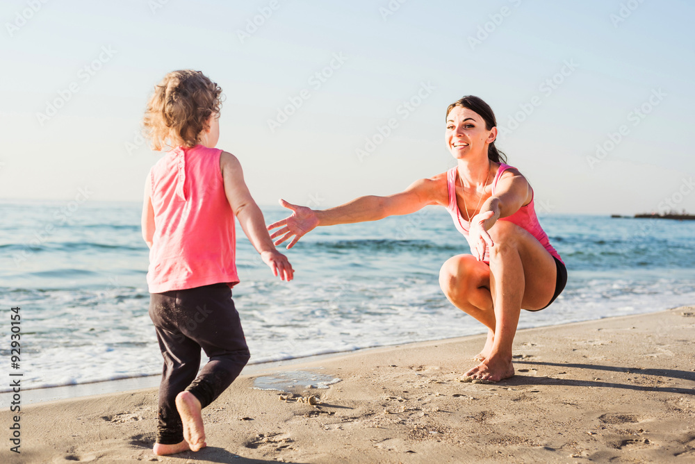 mother and daughter having fun on beach