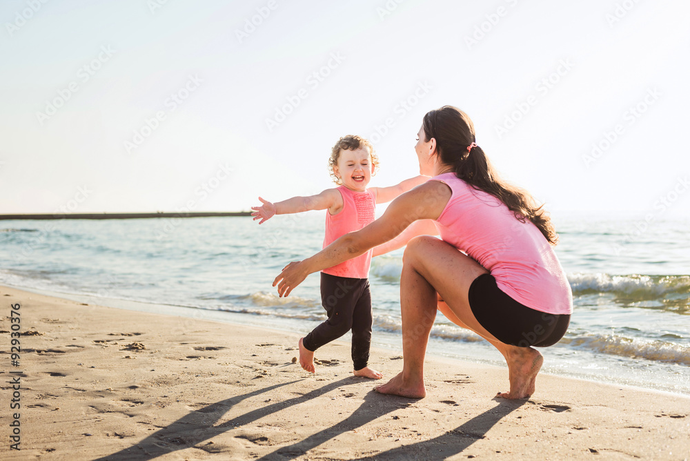 mother and daughter having fun on beach mother and daughter having fun on beach