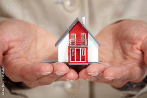 Hands with little house.