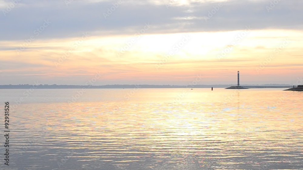 Water landscape with lighthouse and sky during daybreak Water landscape with lighthouse and sky during daybreak