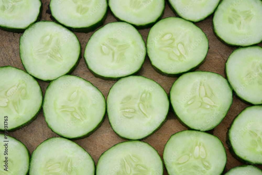 fresh cucumber slices on a wooden chop board