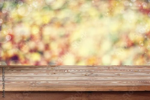 Empty wooden table on an indistinct background with a side.