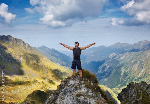 Happy man on mountain cliff