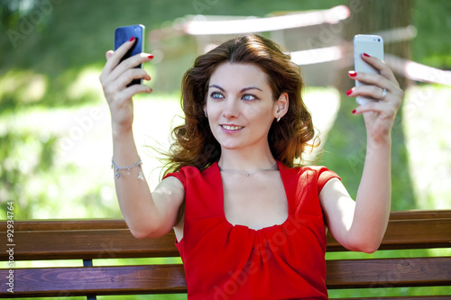 Woman with two smartphones catches Wi fi