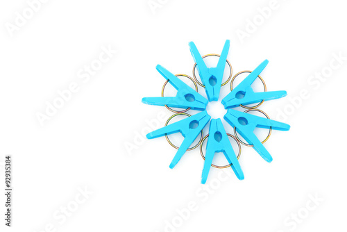 blue clothespins line up as a circle on a white background