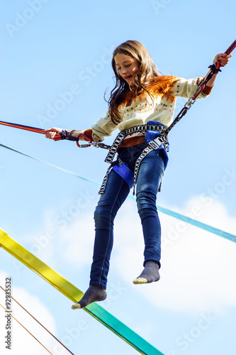 Print op canvas Teenage girl jumping with bungie