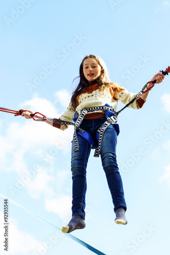 Photography Teenage girl jumping with bungie