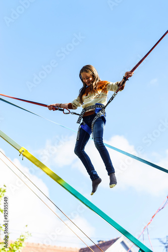 Obraz na plátne Teenage girl jumping with bungie