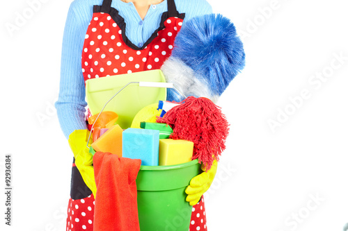 Maid hands with cleaning tools.