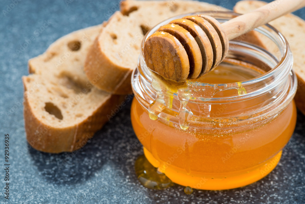 jar with honey and bread, close-up jar with honey and bread, close-up