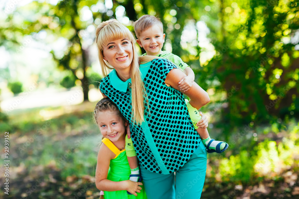 Fototapeta premium Happy young family, mother and childrens together having fun out