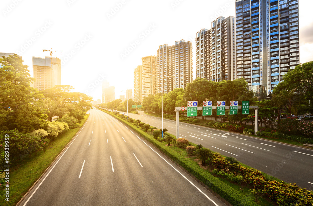 empty asphalt road in modern city under twilight