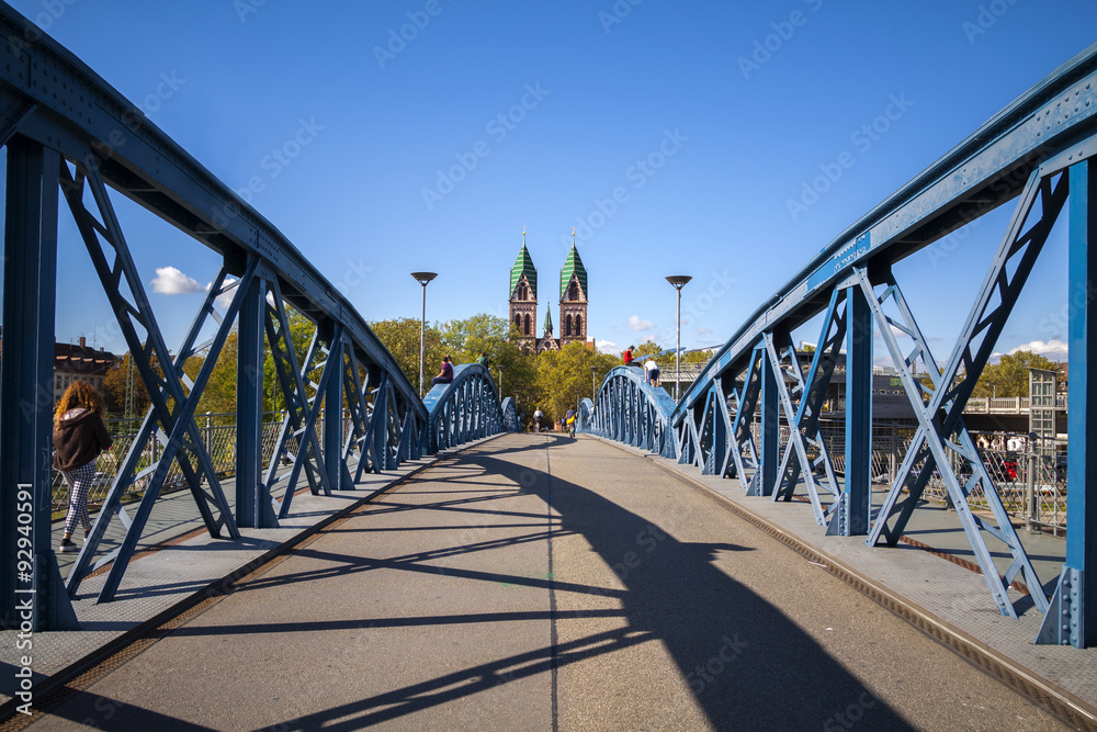 Herz-Jesu Cathedral in Freiburg, Germany, Wiwili blue bridge in front