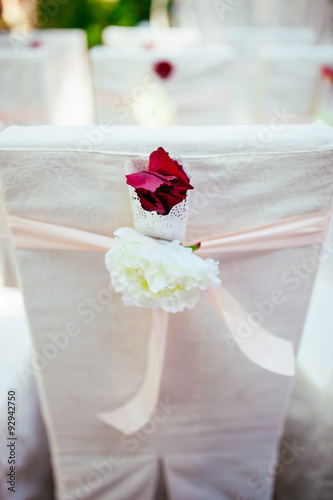 Wedding ceremony chairs. Floral arrangement at a wedding ceremon photo