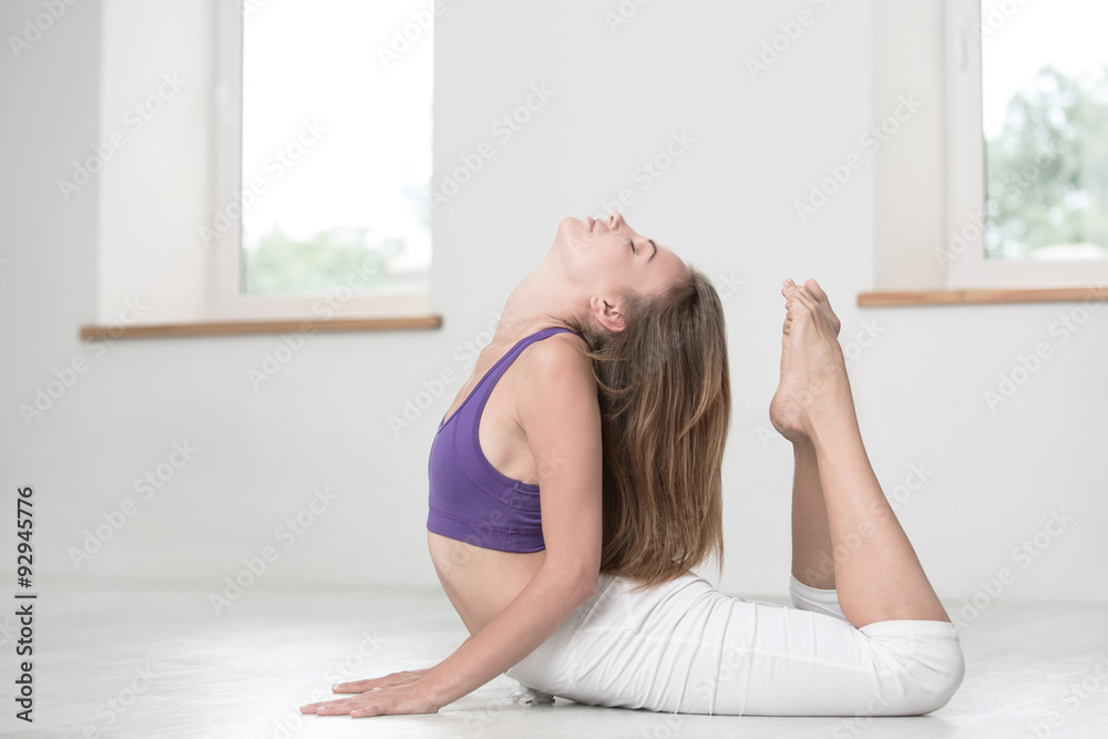 Woman doing stretching exercises in gym Woman doing stretching exercises in gym