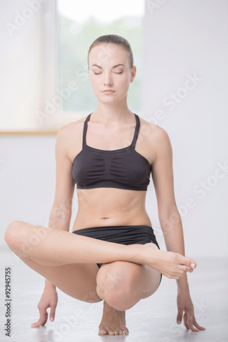 Woman doing yoga exercises in gym