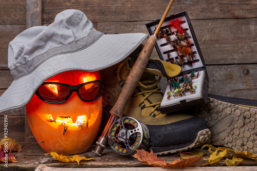 halloween pumpkin with wading boots and fly-fishing