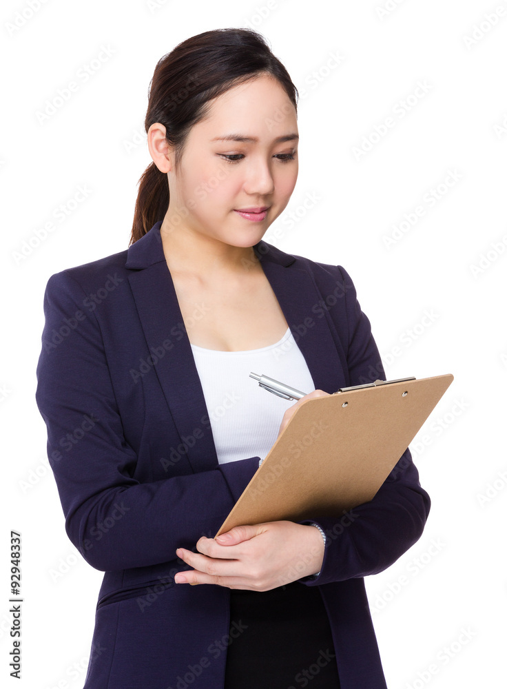 Asian businesswoman take note on clipboard Asian businesswoman take note on clipboard