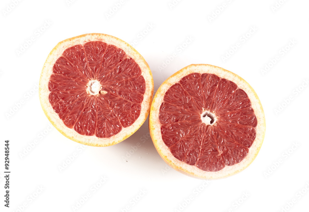 Two halfs of cutted red grapefruit isolated on white
