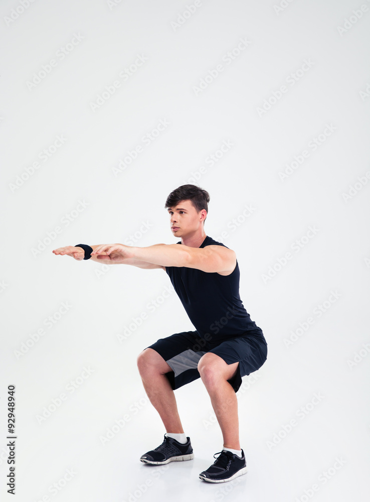 Fitness man doing squatting exercises