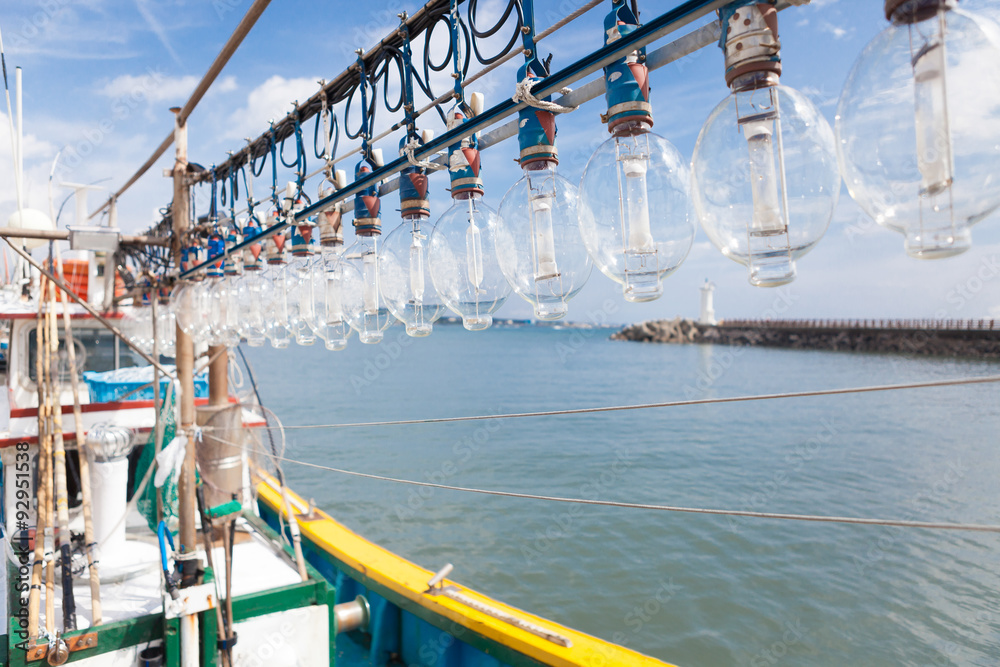 Squid fishing boat entering port in the morning