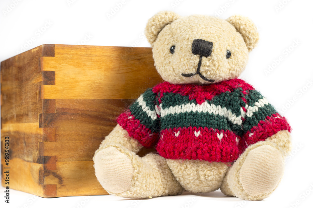 Obraz premium Teddy bear with red wool coat, on white background