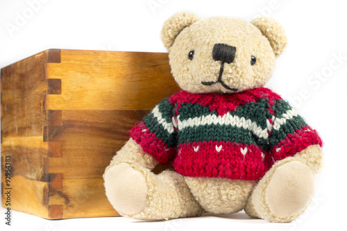 Teddy bear with red wool coat, on white background