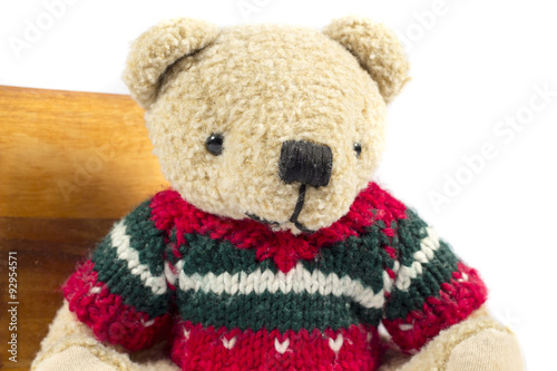 Teddy bear with wool coat, on white