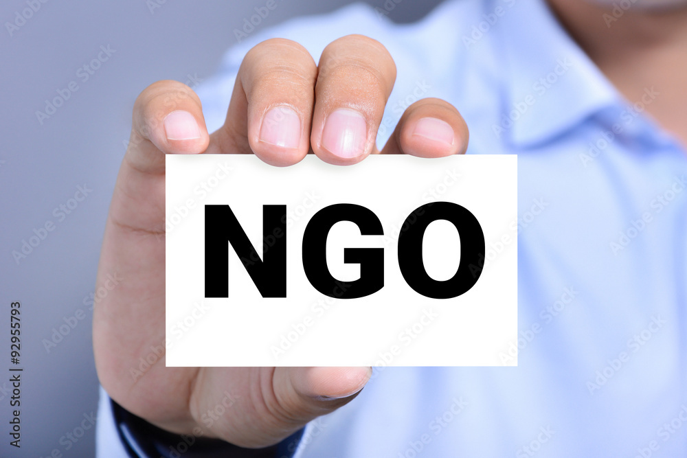NGO letters (or Non-Governmental Organization) on the card shown by a man NGO letters (or Non-Governmental Organization) on the card shown by a man