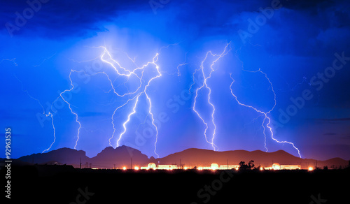 Lighting strike over Palo Verde Nuclear Generating Station behind Saddleback Mountain, Arizona, USA photo