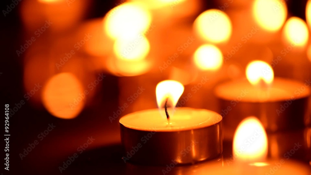 Candles light background. Candle flame at night. Abstract glowing background Candles light background. Candle flame at night. Abstract glowing background