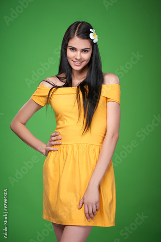 Lovely girl in yellow strapless dress feeling shy